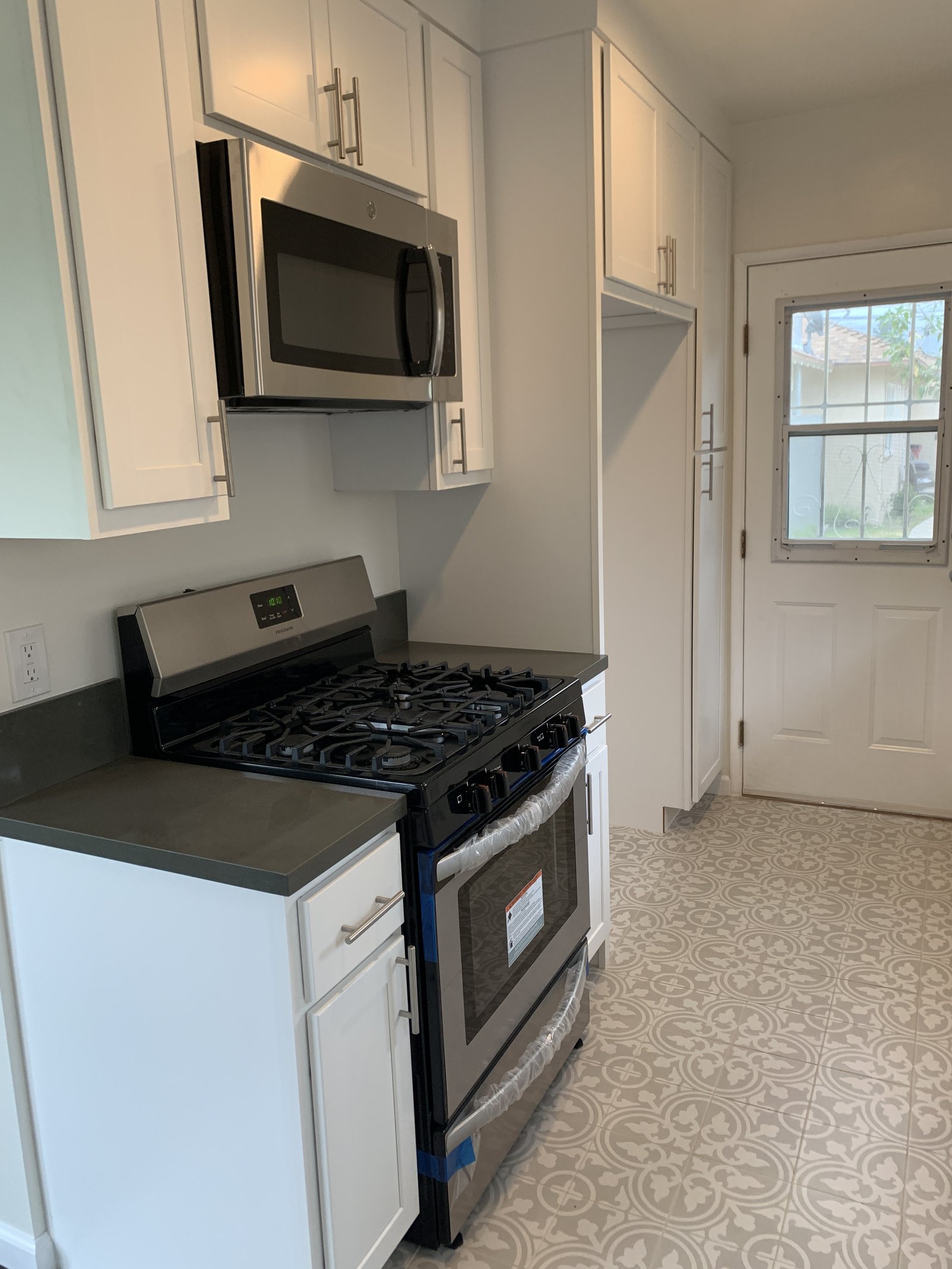 Kitchen with a patterned tile floor, original unaltered photo